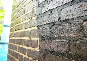 Close-up of brick wall showcasing repointing work, highlighting new mortar application and structural restoration for enhanced aesthetic appeal.