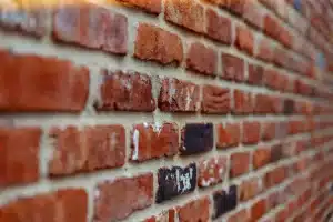 Close-up of a weathered brick wall showing various shades and textures, relevant to professional brick cleaning and restoration techniques for maintaining London homes.